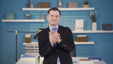 Happy-businessman-looking-at-camera-congratulating-and-clapping.